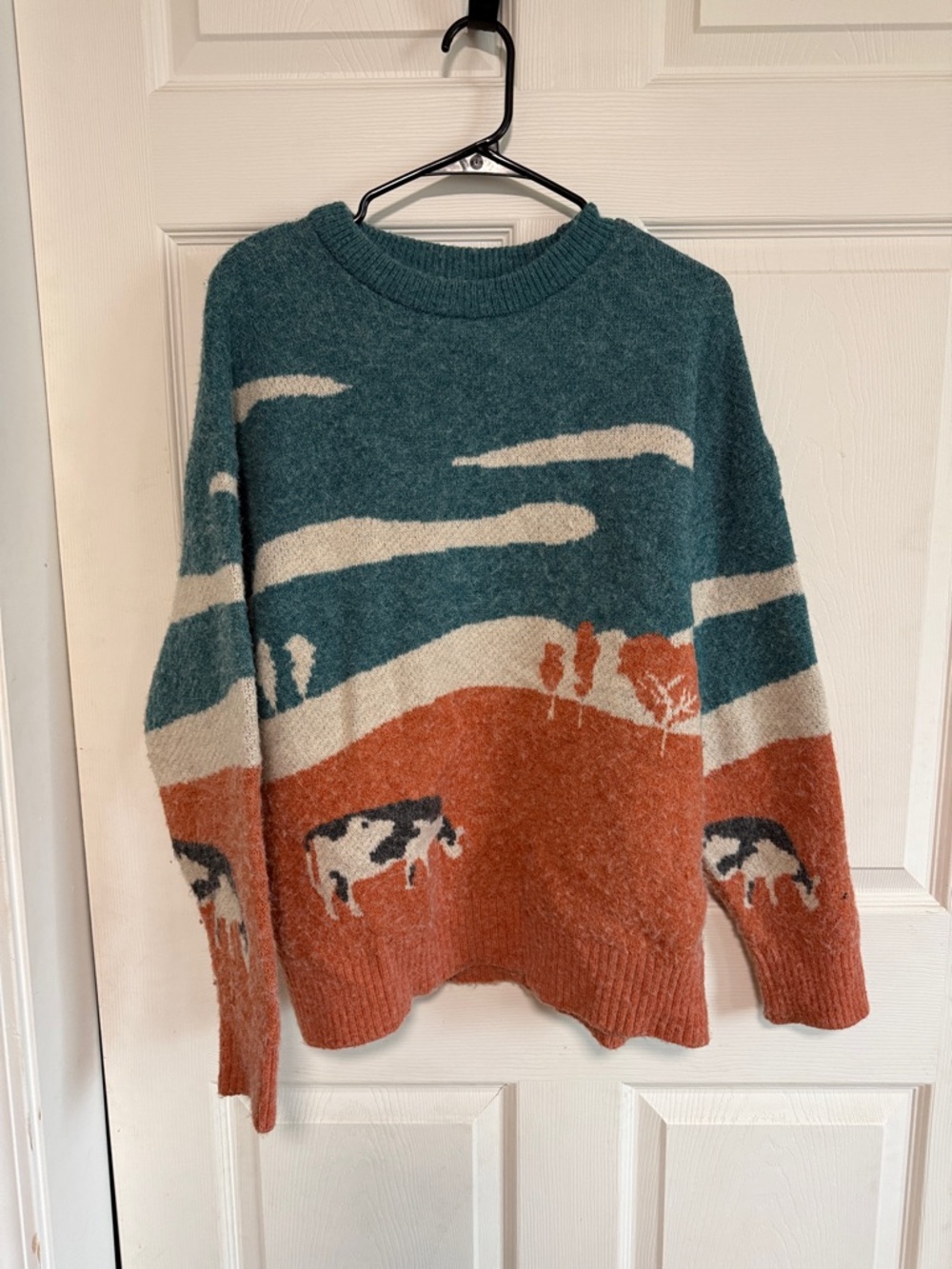 Cozy Teal and Rust Scenic Cow-Print Sweater